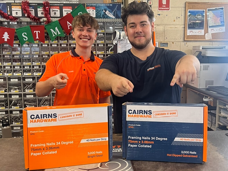 Two Cairns Hardware workers smiling and gesturing to products