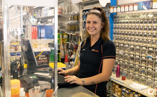 A Cairns Hardware employee smiling to camera