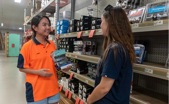 Two Cairns Hardware employees discussing products